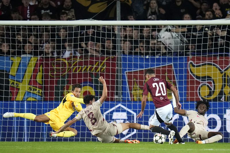 Sparta's Qazim Laci, center right, is about toscore his sides third goal past Salzburg's goalkeeper Janis Blaswich, left, during the Champions League opening phase soccer match between Sparta Prague and Salzburg in Prague, Czech Republic, Wednesday, Sept. 18, 2024. (AP Photo/Petr David Josek)