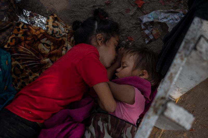 The Bolaños sisters from Venezuela sleep on the ground outside a bus terminal where they are living with their single mother Keilly and two other siblings, alongside other migrants in Villahermosa, Mexico, Saturday, June 8, 2024. Their mother said she was seeking asylum hoping to treat her her four-year-old daughter, right, for leukemia, due to lack of access to medical care back in Venezuela. (AP Photo/Felix Marquez)