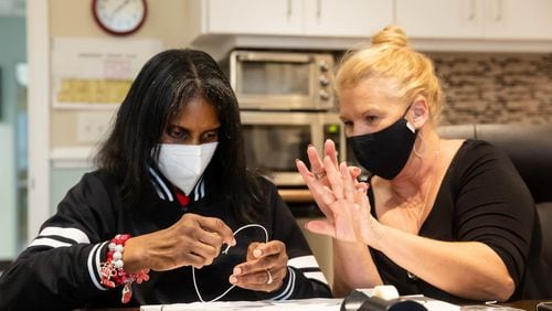 Andrea Brown feels the heart that Leslie Eatherly, Director of Development, helped her create Tuesday afternoon at the Savannah Center for the Blind and Low Vision. Each participant was encouraged to create an expressive shape representing their emotional journey.