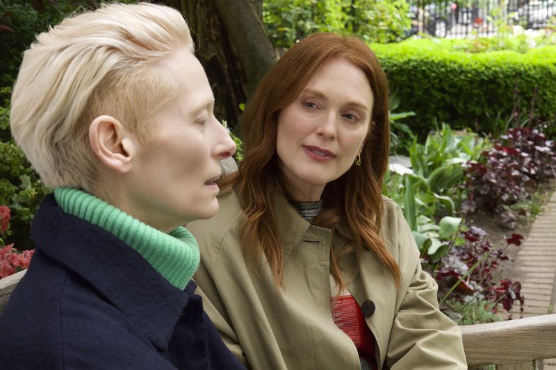 This image released by Sony Pictures Classics shows Julianne Moore, right, and Tilda Swinton in a scene from "The Room Next Door." (Sony Pictures Classics via AP)