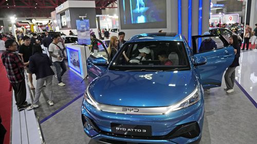 People inspect electric vehicles made by Chinese automaker BYD during an auto fair in Jakarta, Indonesia, Wednesday, June 19, 2024. Investment in electric vehicle manufacturing is booming in Morocco, a country that neighbors Europe and enjoys a free trade agreement with the United States. That's partially because Chinese firms see it as a side door to access the U.S. market and new Biden administration subsidies designed to shut them out. (AP Photo/Achmad Ibrahim)