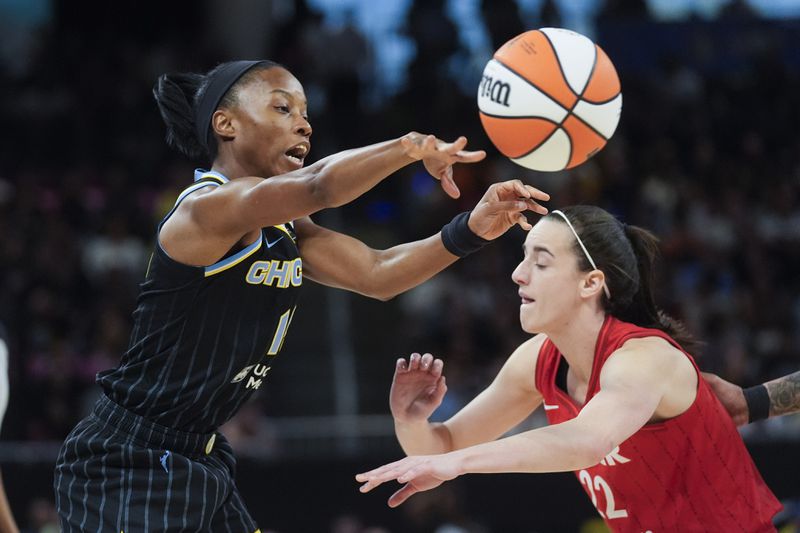 Chicago Sky guard Lindsay Allen, left, passes the ball by Indiana Fever guard Caitlin Clark during the first half of a WNBA basketball game Friday, Aug. 30, 2024, in Chicago. (AP Photo/Erin Hooley)