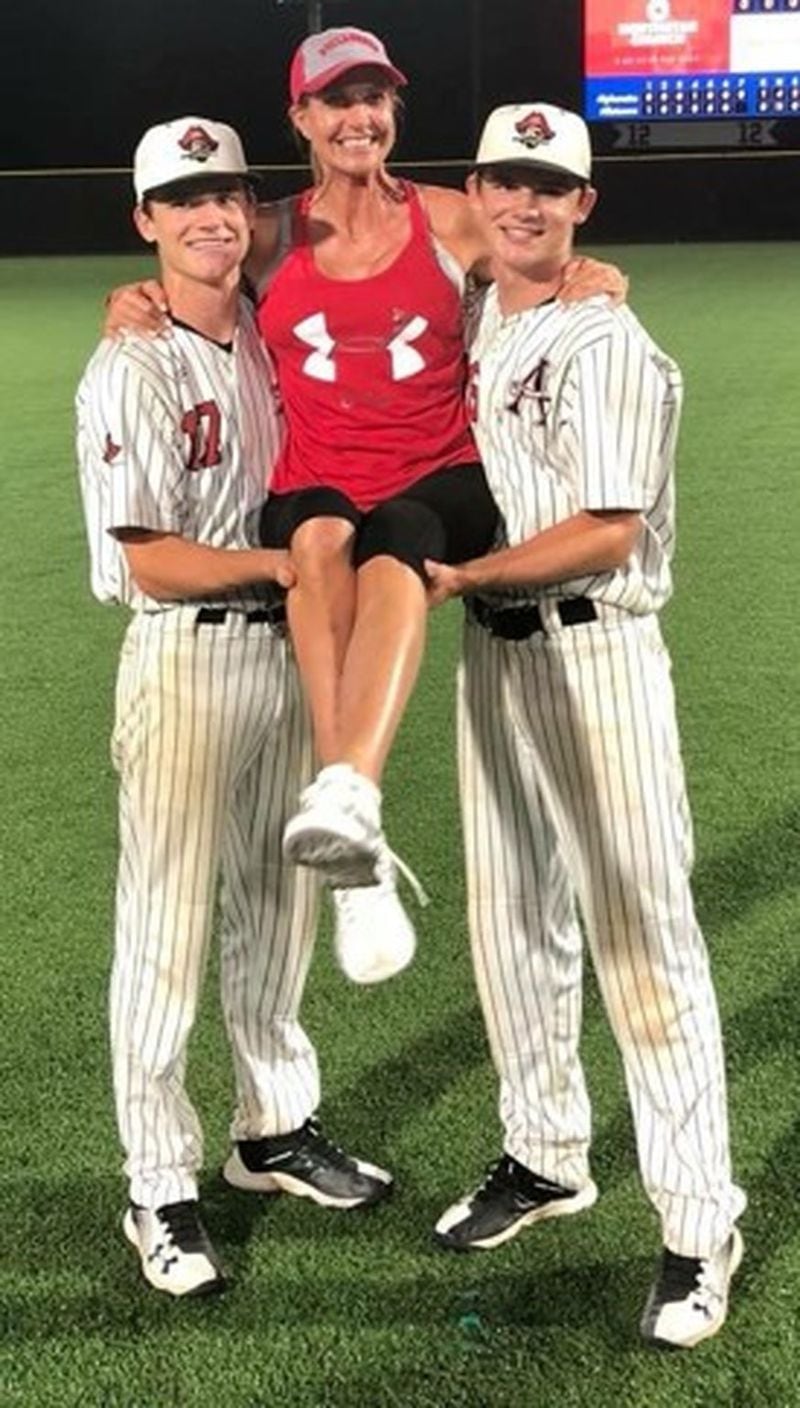 Hunter and Fisher pose with their mom, Janet Paulsen, after a Final Four Game win at the GHSA Baseball State Championship in 2018. CONTRIBUTED