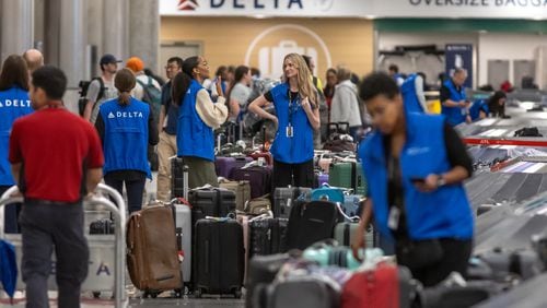 Delta Air Lines employees were busy Wednesday, July 24, 2024, at Hartsfield-Jackson International Airport as operations started to recover from a meltdown that left hundreds of thousands of travelers stranded around the country over the last five days last month. (John Spink/AJC)