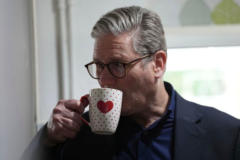 British Labour Party leader Sir Keir Starmer has a drink as he speaks to voters about the cost of living, while on the General Election campaign trail in Stafford, in the West Midlands, England, Saturday May 25, 2024. ( Jacob King/PA via AP)