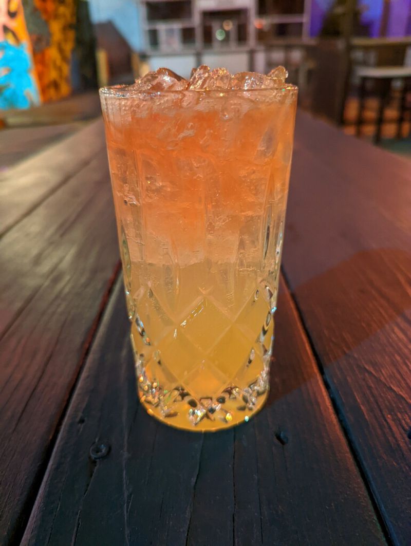 8Arm's Red Menace is is a mix of non-Russian vodka, slivovitz--a blue plum brandy that is produced all over Eastern Europe, lemon, honey and soda, which is then topped off with red Creole Bitters