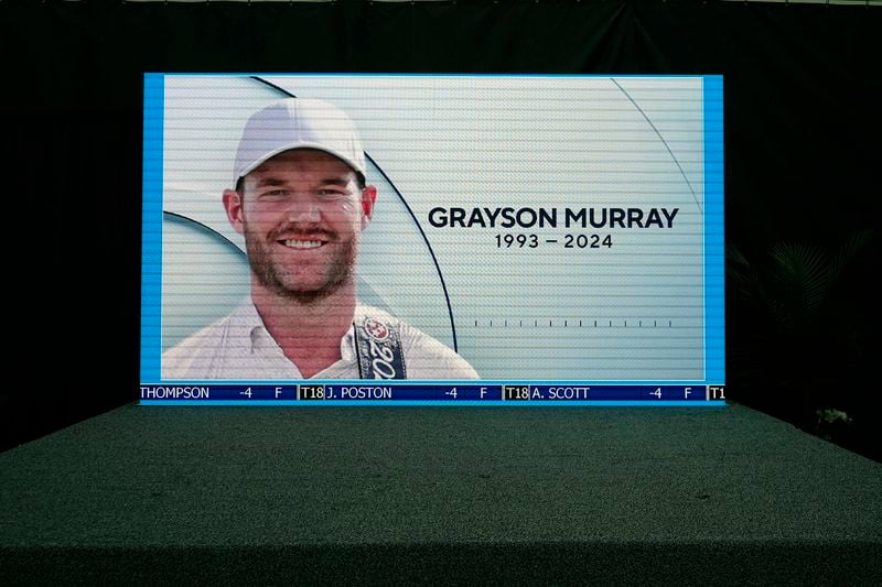 A golf broadcast by CBS is played on an empty stage at the media center showing a photo of Grayson Murray during the third round of the Charles Schwab Challenge golf tournament at Colonial Country Club in Fort Worth, Texas, Saturday, May 25, 2024. Two-time PGA Tour winner Murray died Saturday morning at age 30, one day after he withdrew from the tournament. (AP Photo/LM Otero