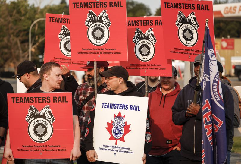 Teamsters Canada Rail Conference members picket outside the CPKC headquarters in Calgary, Alta., Friday, Aug. 23, 2024.(Jeff McIntosh /The Canadian Press via AP)