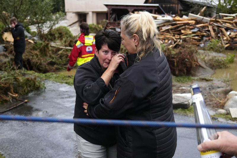 A resident hugs with her relative after being evacuated from her flooded house in Jesenik, Czech Republic, Sunday, Sept. 15, 2024. (AP Photo/Petr David Josek)