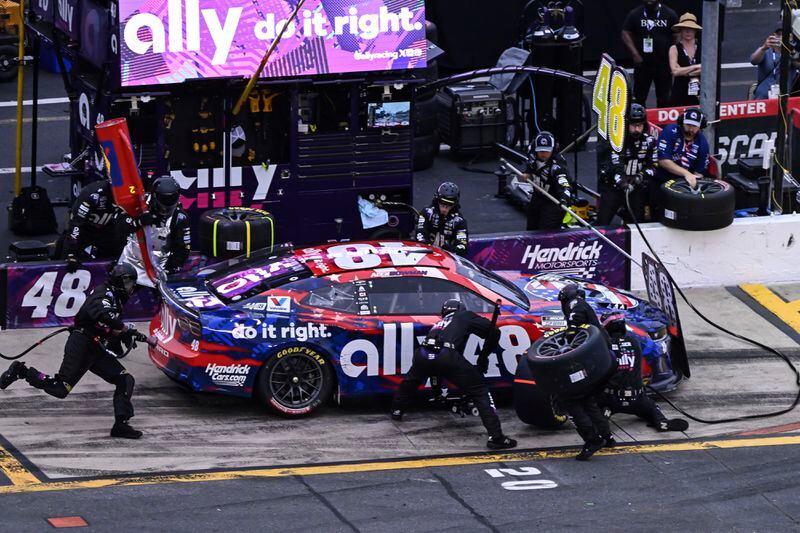 The pit crew for Alex Bowman rushes to complete a pit stop during a NASCAR Cup Series auto race at Charlotte Motor Speedway, Sunday, May 26, 2024, in Concord, N.C. (AP Photo/Matt Kelley)