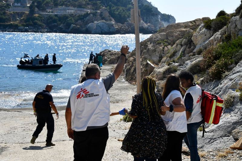 Members of Doctors Without Borders help a pregnant woman who survived after a boat carrying migrants ran into trouble off the coast of the eastern Aegean Sea island of Samos, Greece, on Monday, Sept. 23, 2024. (AP Photo/Michael Svarnias)