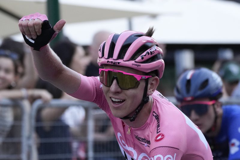 Slovenia's Tadej Pogacar, wearing the pink jersey overall leader, crosses the finish line of the 21st and last stage of the Giro D'Italia, tour of Italy cycling race, in Rome, Sunday, May 26, 2024. (AP Photo/Andrew Medichini)