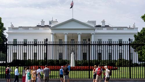 Visitors stand outside the White House, Tuesday, July 23, 2024, in Washington. (AP Photo/Julia Nikhinson)