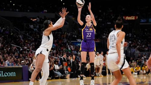 Los Angeles Sparks forward Cameron Brink (22) shoots against Las Vegas Aces center A'ja Wilson, left, and guard Kelsey Plum during the second half of a WNBA basketball game, Sunday, June 9, 2024, in Los Angeles. (AP Photo/Ryan Sun)