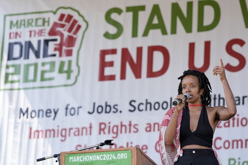 Jamila Woods sings during a demonstration before a march to the Democratic National Convention Monday, Aug. 19, 2024, in Chicago. (AP Photo/Alex Brandon)