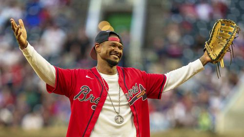 Grammy winning artist, Usher, throws out the ceremonial first pitch of a baseball game between the Los Angeles Dodgers and the Atlanta Braves, Saturday, Sept. 14, 2024, in Atlanta. The Braves won the game 10-1.  (AP Photo/Jason Allen)