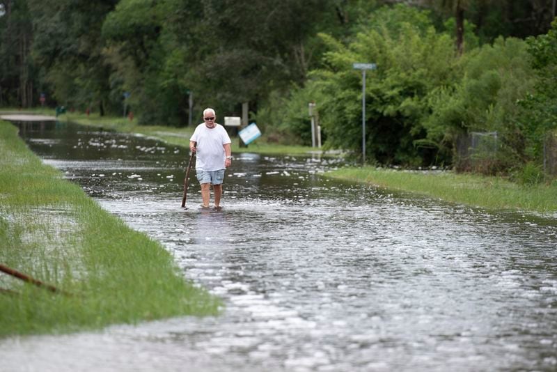 A man walks through floodwaters along Tigris Street in Shoreline Park in Hancock County, Miss., after Hurricane Francine on Thursday, Sept. 12, 2024. (Hannah Ruhoff/The Sun Herald via AP)