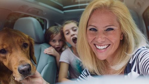 Atlanta-based photographer Kate Parker, pictured with her kids and dog, has a new book filled with girls (and women) finding and using their voices. Image credit: Workman Press.