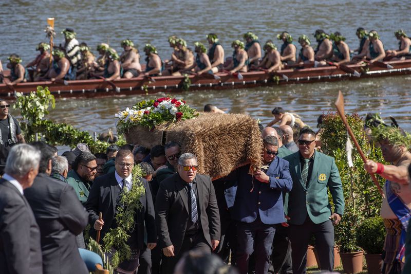 The coffin with the body of New Zealand's Maori King, Kiingi Tuheitia Pootatau Te Wherowhero VII, is carried after being transported on a waka (a traditional canoe) for burial in Ngaruawahia, New Zealand, Thursday, Sept. 5, 2024. (AP Photo/Alan Gibson)