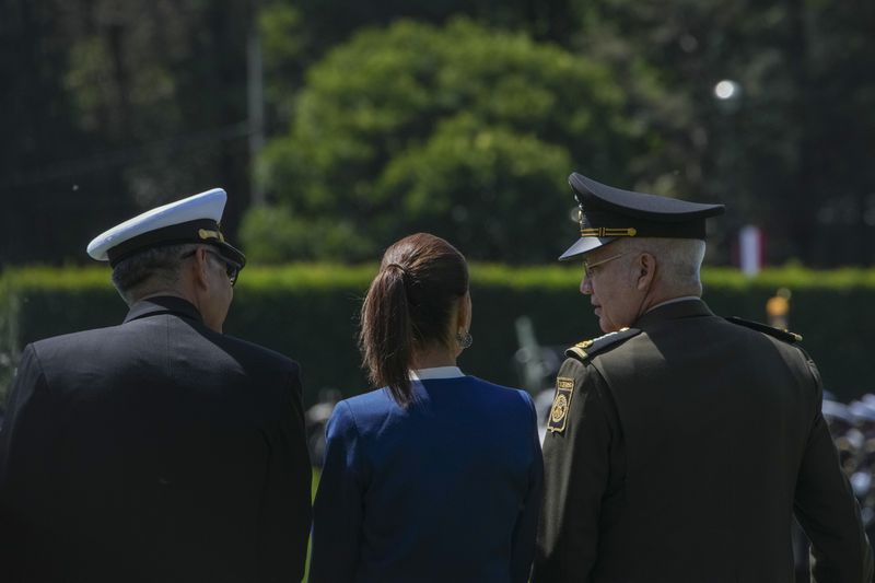 Mexican President Claudia Sheinbaum, center, reviews the troops with Defense Minister Gen. Ricardo Trevilla Trejo, right, and Navy Secretary Alt. Raymundo Pedro Morales at Campo Marte in Mexico City, Thursday, Oct. 3, 2024. (AP Photo/Fernando Llano)