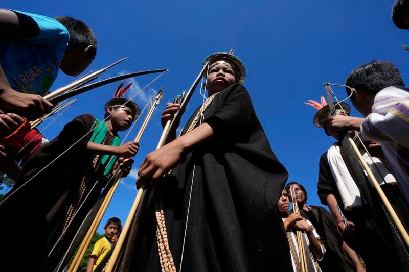 Ashaninka Indigenous children prepare for a bow and arrow competition during the annual celebration recognizing the Ashaninka territory in the Apiwtxa village, Acre state, Brazil, Sunday, June 23, 2024. (AP Photo/Jorge Saenz)