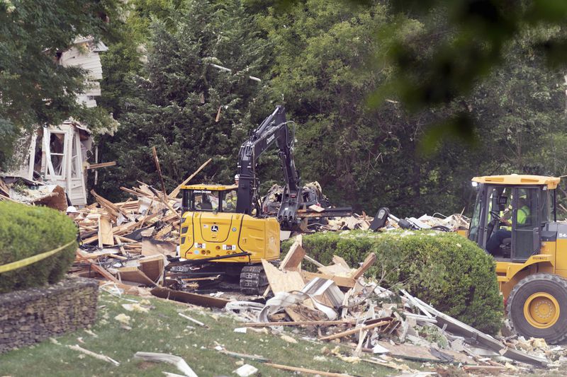 Crew workers remove debris after a house exploded in Bel Air, Md. neighborhood on Sunday, Aug. 11, 2024. (AP Photo/Jose Luis Magana)