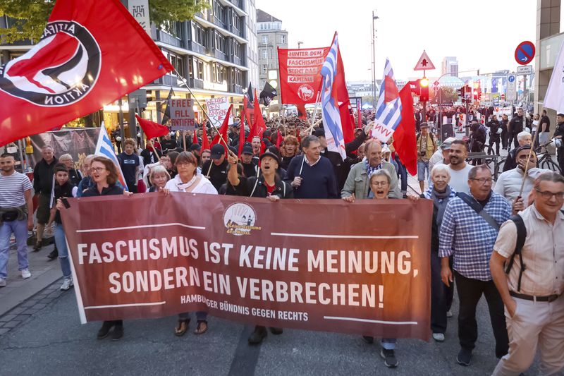 Participants in a demonstration against the right hold a banner reading "Fascism is not an opinion, it's a crime!" in Hamburg, Sunday, Sept. 1, 2024. (Bodo Marks/dpa via AP)