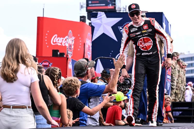 Driver Christopher Bell, right, greets fans prior to a NASCAR Cup Series auto race at Charlotte Motor Speedway, Sunday, May 26, 2024, in Concord, N.C. (AP Photo/Matt Kelley)