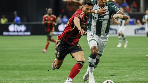 Atlanta United midfielder Pedro Amador, left, battles for posetion against Santos Laguna forward Antony Lozano, right, during the first half of a Leagues Cup match soccer match Sunday, Aug. 4, 2024, in Atlanta. (Miguel Martinez/Atlanta Journal-Constitution via AP)