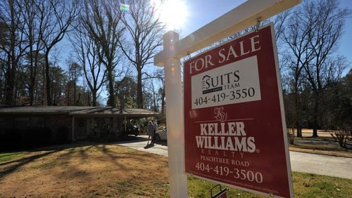 Real estate agent Collette McDonald and her intern Gunner DeLay wait for their client Dawn Ramsey outside a house for sale in Brookhaven on Friday, February 21, 2014. Fewer metro Atlanta houses were sold in January than the year before and the month before - the result of cold weather and supply that remains low. But the median price of purchased homes rose, another result of low inventory and an indication that fewer distressed houses are on the market. HYOSUB SHIN / HSHIN@AJC.COM