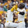 San Diego Padres' Kyle Higashioka, right, celebrate his solo home run with Luis Arraez during the second inning in Game 2 of an NL Wild Card Series baseball game against the Atlanta Braves, Wednesday, Oct. 2, 2024, in San Diego. (AP Photo/Gregory Bull)