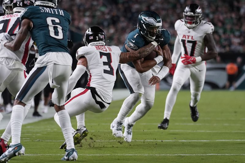 Philadelphia Eagles quarterback Jalen Hurts (1) is stopped by Atlanta Falcons safety Jessie Bates III (3) during the first half of an NFL football game Monday, Sept. 16, 2024, in Philadelphia. (AP Photo/Matt Rourke)