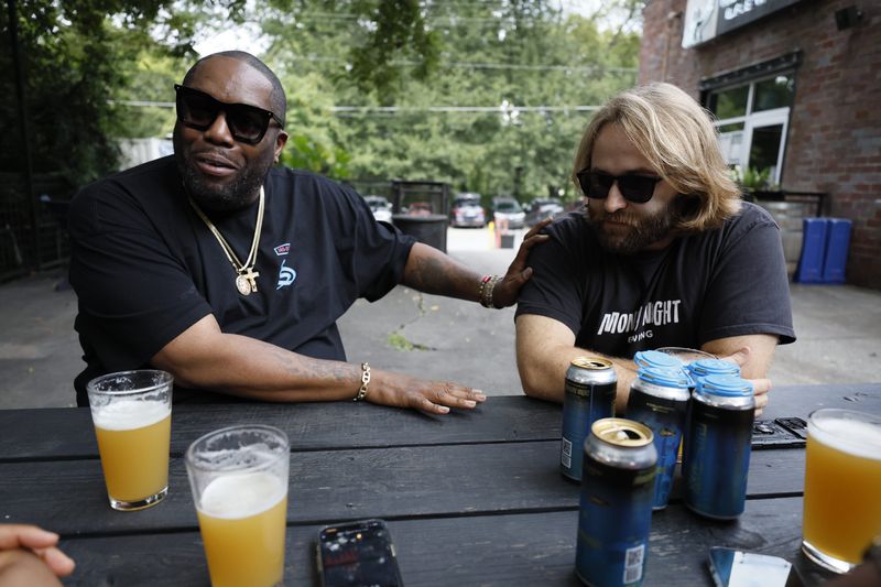 Rapper Killer Mike and Peter Kiley, brewmaster at Monday Night Brewery, speak during an interview with The Atlanta Journal-Constitution about their partnership to benefit the nonprofit organization PAWKids. (Photo: Miguel Martinez / miguel.martinezjimenez@ajc.com)