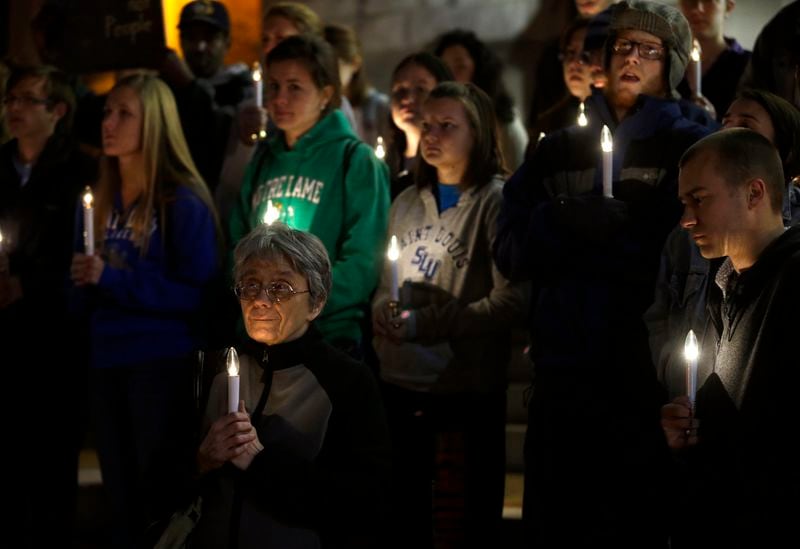 FILE - In this Nov. 19, 2013 file photo, a small group of death penalty opponents stand outside St. Francis Xavier Church during a vigil in protest of the scheduled execution of Missouri death row inmate Joseph Paul Franklin in St. Louis. (AP Photo/Jeff Roberson, File)