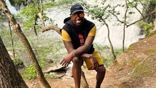 Rashad "Big Bank" Holsey, Sr. poses during a hike.