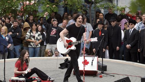 FILE - Musicians Jack White, right, and Meg White of the band The White Stripes perform an impromptu concert in Whitehorse, Yukon, Canada, June 25, 2007. (AP Photo/The Canadian Press, Vince Fedoroff, File)