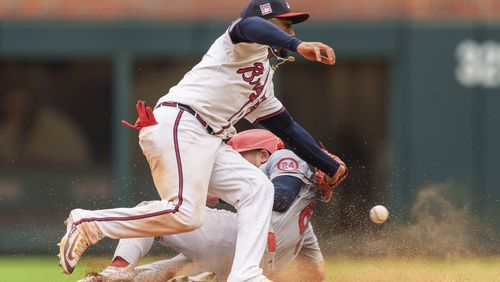 Atlanta Braves second baseman Ozzie Albies, top, attempts to tag out St. Louis Cardinals Michael Siani, bottom, in the eighth inning of a baseball game, Sunday, July 21, 2024, in Atlanta. (AP Photo/Jason Allen)