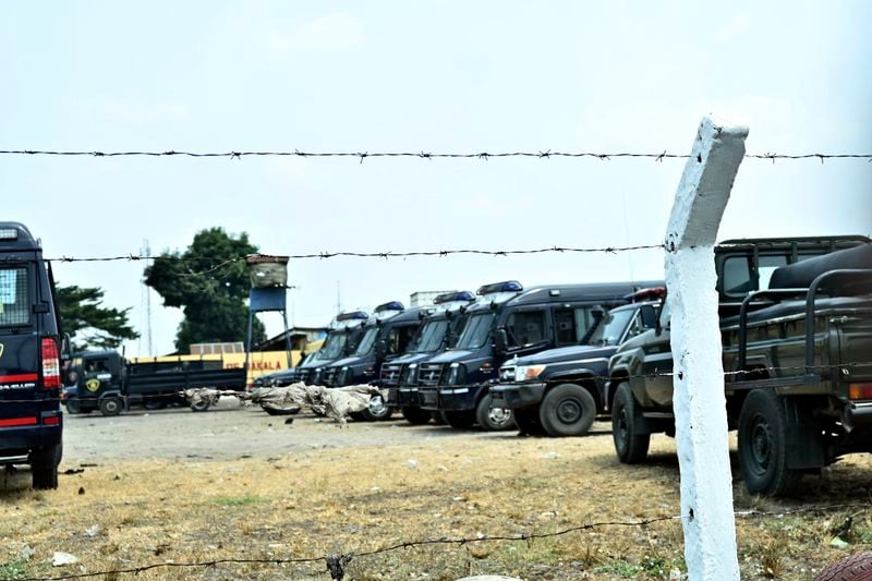 Police vehicles are seen outside the Makala Central prison in Kinshasa, Congo, Tuesday, Sept. 3, 2024 after an attempted jailbreak in Congo’s main prison that left many people dead. (AP Photo/Samy Ntumba Shambuyi)