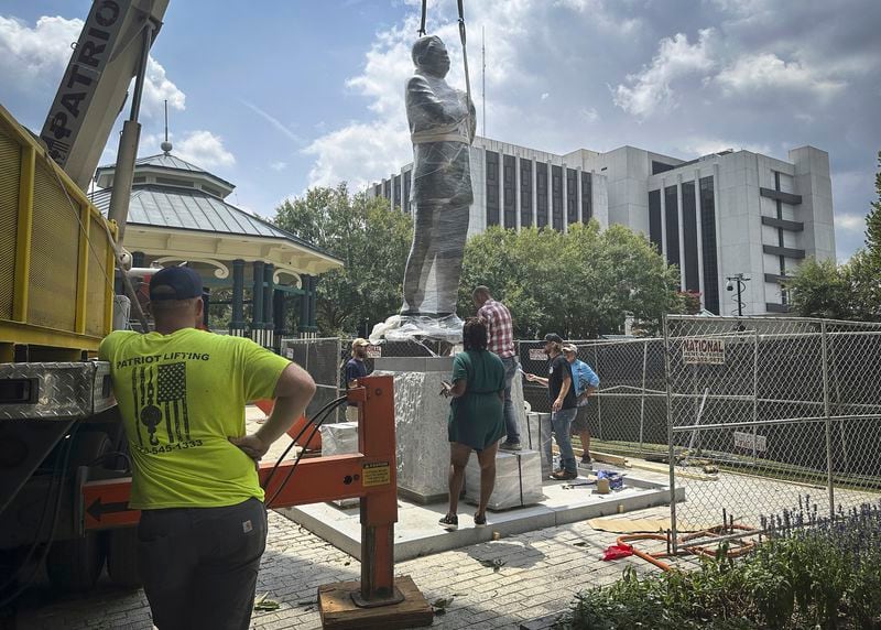 A large bronze statue of the late civil rights leader and politician Congressman John Lewis is installed where a monument to the Confederacy was brought down in 2020, in the wake of the death of George Floyd, Friday, Aug. 16, 2024, in Decatur, Ga. (AP Photo/Ron Harris)