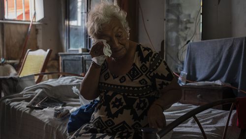 FILE - Margarita Salazar, 82, wipes the sweat off with a tissue inside her home in Veracruz, Mexico on June 16, 2024. (AP Photo/Felix Marquez, File)