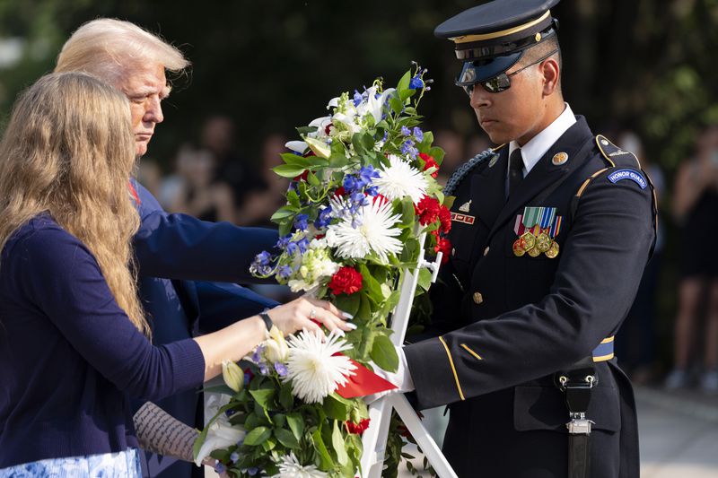 Misty Fuoco, left, sister of Nicole Gee, and Republican presidential nominee former President Donald Trump place a wreath in honor of Sgt. Nicole Gee, at the Tomb of the Unknown Solider at Arlington National Cemetery, Monday, Aug. 26, 2024, in Arlington, Va. (AP Photo/Alex Brandon)