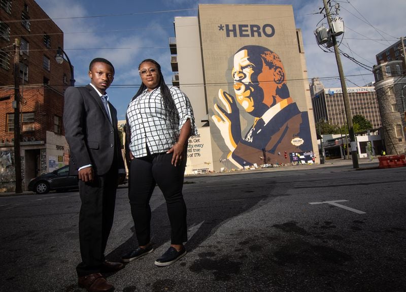 Mary-Pat Hector (R) and Jared Sawyer pose for a photograph in front of the  John Lewis mural on Auburn Ave in Atlanta, August 6, 2020.  STEVE SCHAEFER FOR THE ATLANTA JOURNAL-CONSTITUTION