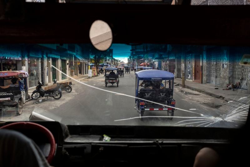 Mototaxis circulate in the Belen neighborhood of Iquitos, Peru, Sunday, May 26, 2024. The Indigenous community in the heart of Peru's Amazon is hosting the Muyuna Floating Film Festival, that showcases films from tropical forests. (AP Photo/Rodrigo Abd)