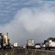 Westbound traffic on I-20 approach the plume of smoke rising from BioLab that continued on Thursday, Oct. 3, 2024 in Conyers. A Sunday fire at the chemical plant in Conyers has had agencies monitoring the air quality since then as crews try to neutralize the site. Rockdale County officials said that the plume is changing colors as workers remove debris. GEMA has advised anyone who notices a chlorine odor in the air to limit their time outdoors. (John Spink/AJC)