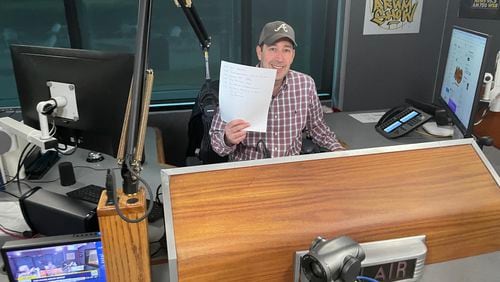 WSB Radio morning host Mark Arum displays his old-school listing of the upcoming show. The AJC's Bill Torpy writes that Arum is unusual in talk radio as he does not hector, holler or heckle.