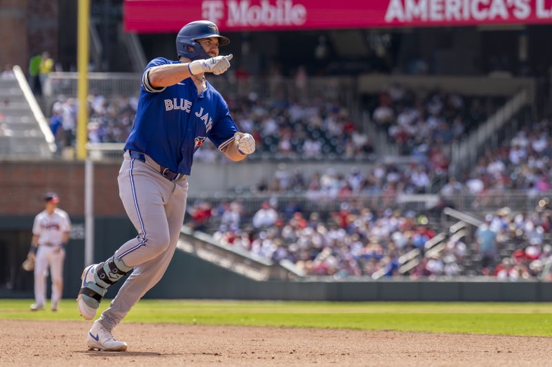 Toronto Blue Jays second base Spencer Horwitz (48) scores a run during the 8th inning of a baseball game between the Toronto Blue Jays and the Atlanta Braves, Sunday, Sept. 9, 2024, in Atlanta. (AP Photo/Erik Rank)