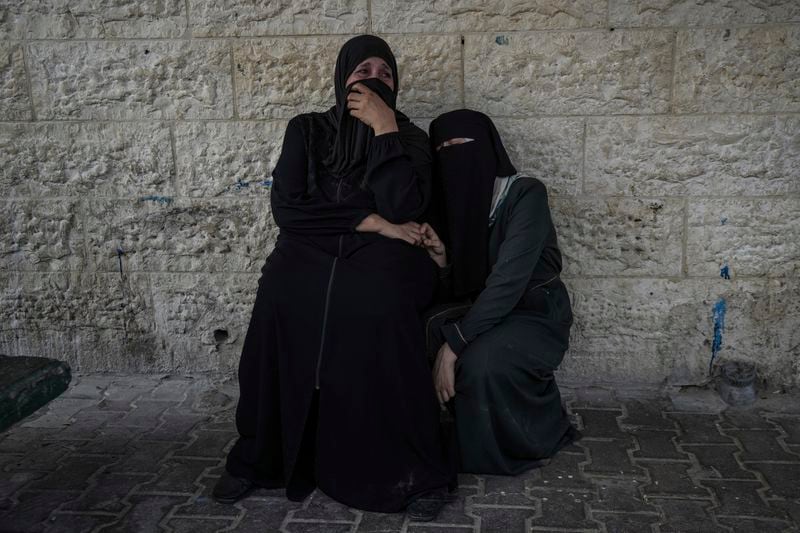 Palestinian women mourn their relatives killed in the Israeli bombardment of the Gaza Strip, at a hospital in Deir al-Balah, Tuesday, Aug. 27, 2024. (AP Photo/Abdel Kareem Hana)