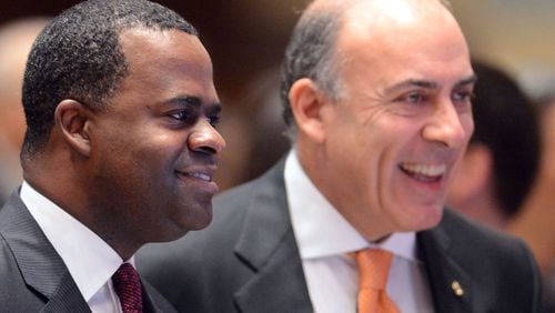 Mayor Kasim Reed (left) and Muhtar Kent greet attendees at the State of the City Speech in February. KENT D. JOHNSON / KDJOHNSON@AJC.COM