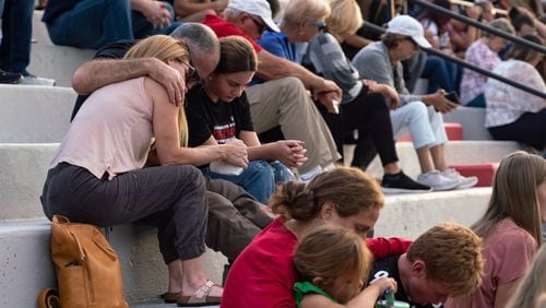 Families bow their heads in prayer. Hundreds gather at Flowery Branch High School  to celebrate the life of Ricky Aspinwall II. Sunday, Sept. 8, 2024 (Ben Hendren for the Atlanta Journal-Constitution)