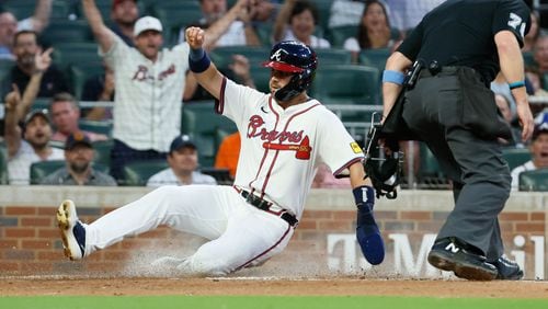 Atlanta Braves outfielder Whit Merrifield (15) slides safely at home on a double by Gio Urshela (9) during the third inning against the Colorado Rockies at Truist Park on Tuesday, Sept. 3, 2024, in Atlanta.
(Miguel Martinez/ AJC)